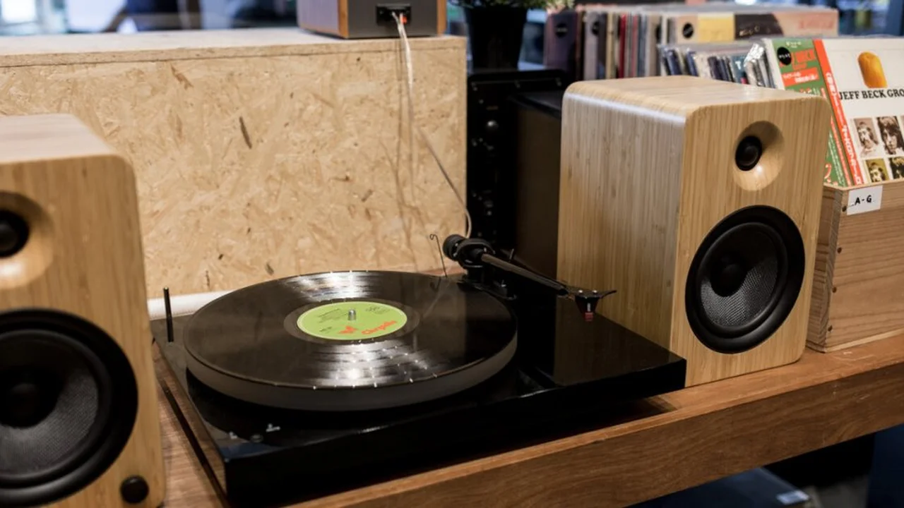 Close up on a plate of mashed potatoes, topped with baked pork chops with cream of mushroom soup, and a side of green beans.