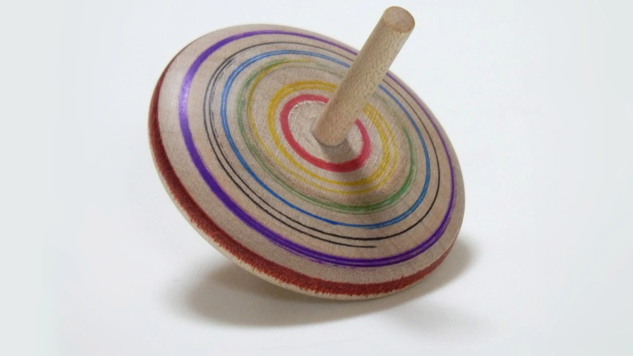 blue bowl of black bean beef tortilla soup on a board with cilantro and shredded cheese in background
